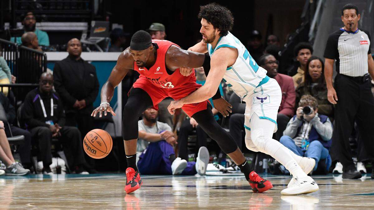 Miami Heat center Bam Adebayo (13) and Charlotte Hornets guard Vasa Micic (22) go after loose ball during the second half at the Spectrum Center.