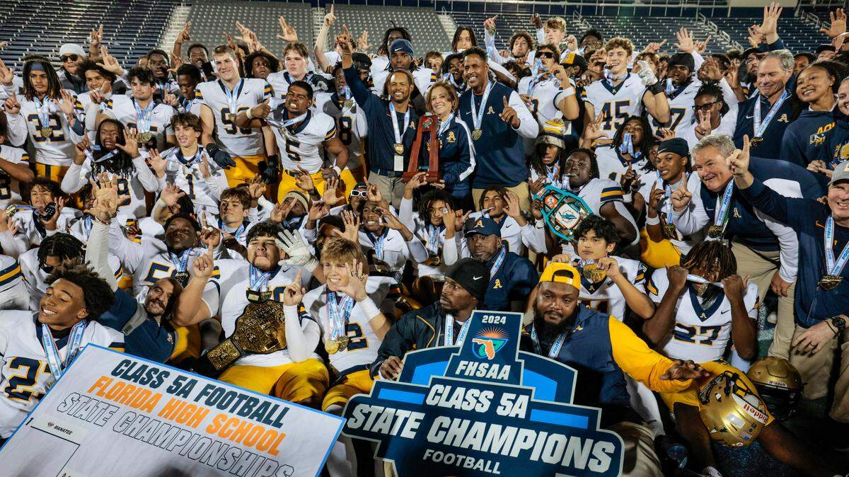 St. Thomas Aquinas players and coaches clebrate the championship win over Lakeland Dreadnaughts in the Florida High School Football State Championships - Class 5A game at Pitbull Stadium on the campus of Florida International University in Miami, Florida, on Thursday, December 12, 2024.