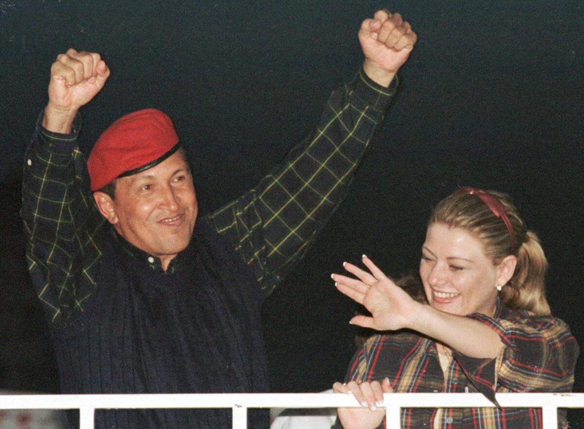 El entonces candidato presidencial Hugo Chávez y su esposa, María Isabel, saludan a los partidarios que asistieron a su mitin de campaña de clausura en Caracas el 2 de diciembre de 1998.