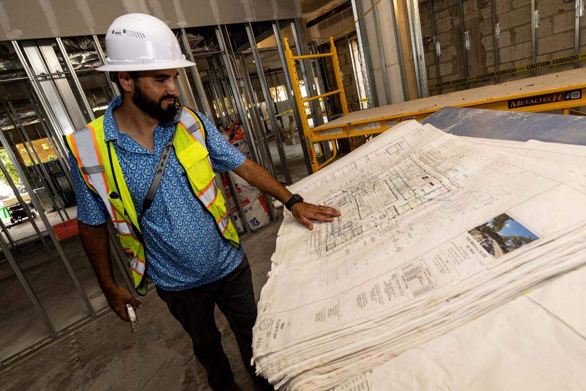 Superintendent Ricardo Sanchez, 34, looks over the first floor blueprints at Miami International Airport’s new VIP terminal on Wednesday, July 23, 2025, in Miami, Fla.
