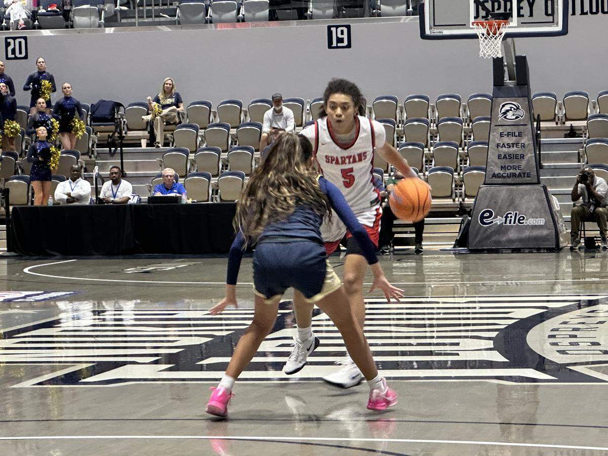 Miami Country Day’s Kamie Ellis gets ready to run a play at the top of the key during Saturday’s Class 2A girls’ basketball state championship game against Melbourne Holy Trinity at UNF Arena in Jacksonville, Fla.