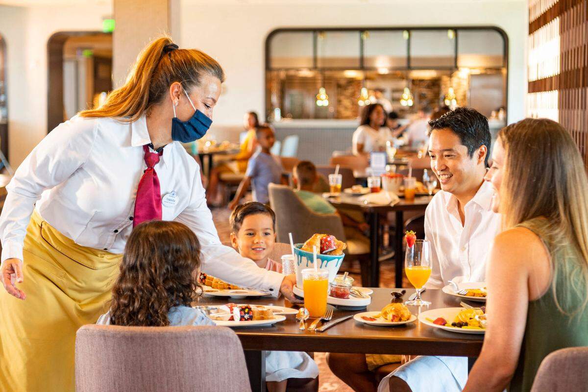 New measures are in place to promote health and well-being in table-service restaurants at Walt Disney World Resort in Lake Buena Vista, Fla. Cast members wear appropriate face coverings at all times, while guests can only remove their face coverings while sitting at their table. (Matt Stroshane, photographer)