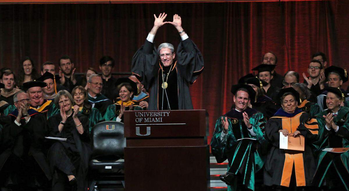  Julio Frenk throws up the ‘U’ after he is installed as the sixth president of the University of Miami at the BankUnited Center, Friday, Jan. 29, 2016.