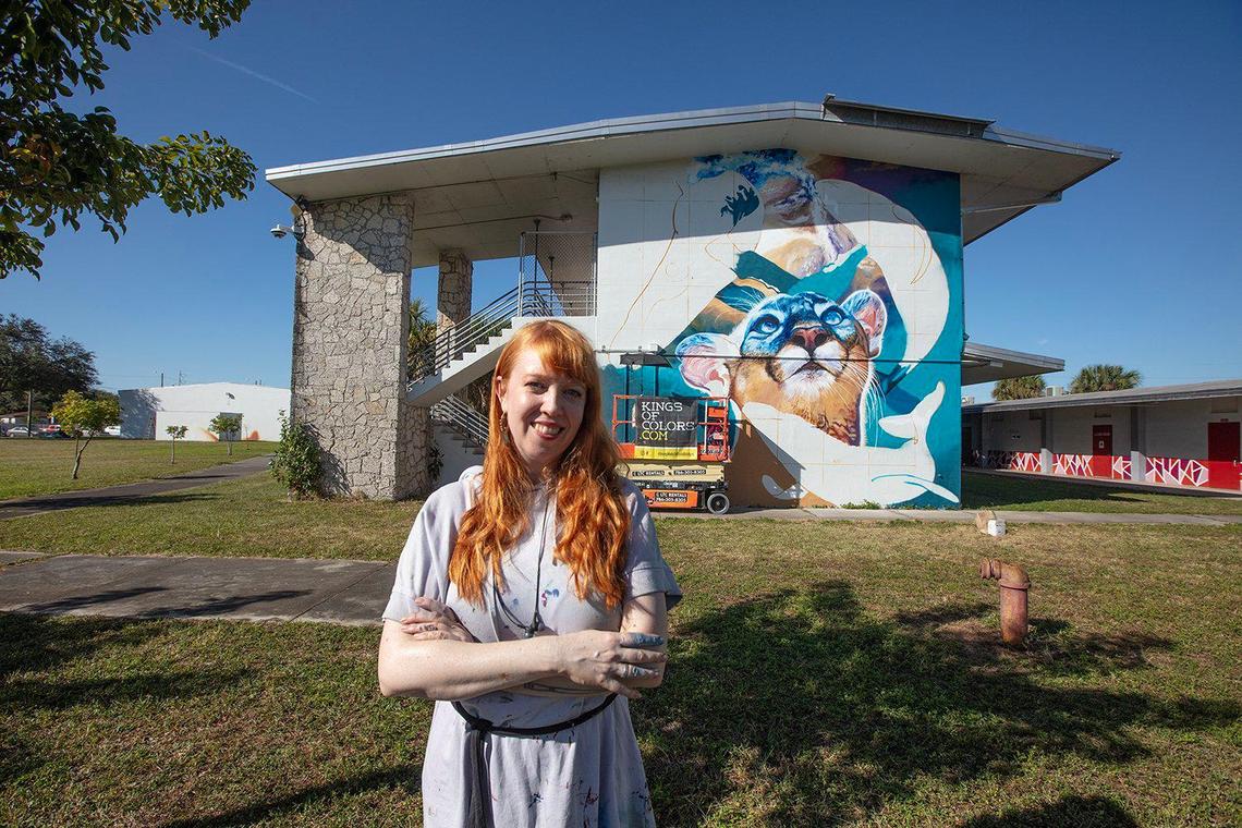 Nina Valkhoff from the Netherlands poses in front of her mural at Madison Middle School in Miami.