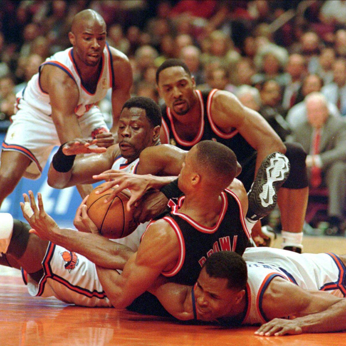 P.J. Brown of the Miami Heat battles with New York Knicks’ Patrick Ewing, left, and Buck Williams, bottom right, for control of the ball during the third quarter Monday night, May 12, 1997, of the Eastern Conference semifinals at New York’s Madison Square Garden. Knicks’ Charlie Ward, upper left, and Miami’s Alonzo Mourning look on. (AP Photo/Mark Lennihan)
