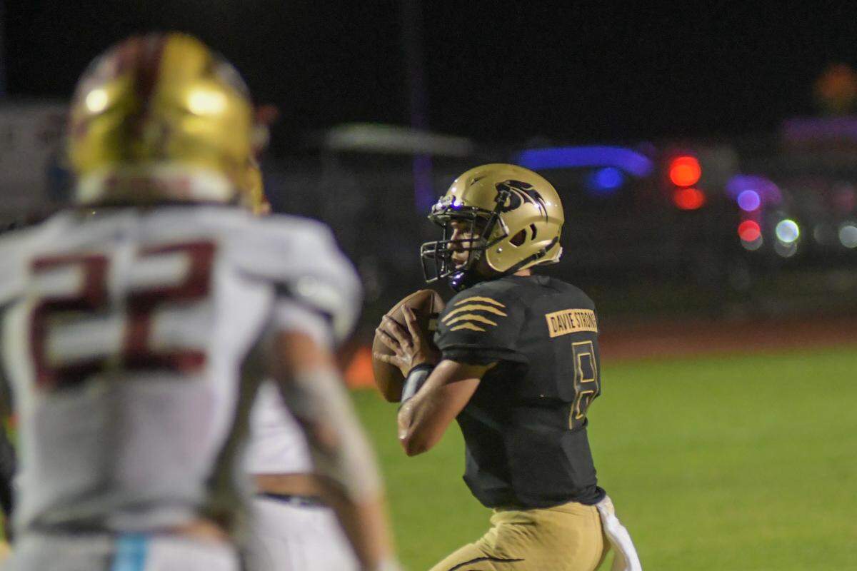 Western quarterback Collin Hurst looks to throw against Johns Creek on Thursday, Aug. 25, 2022.