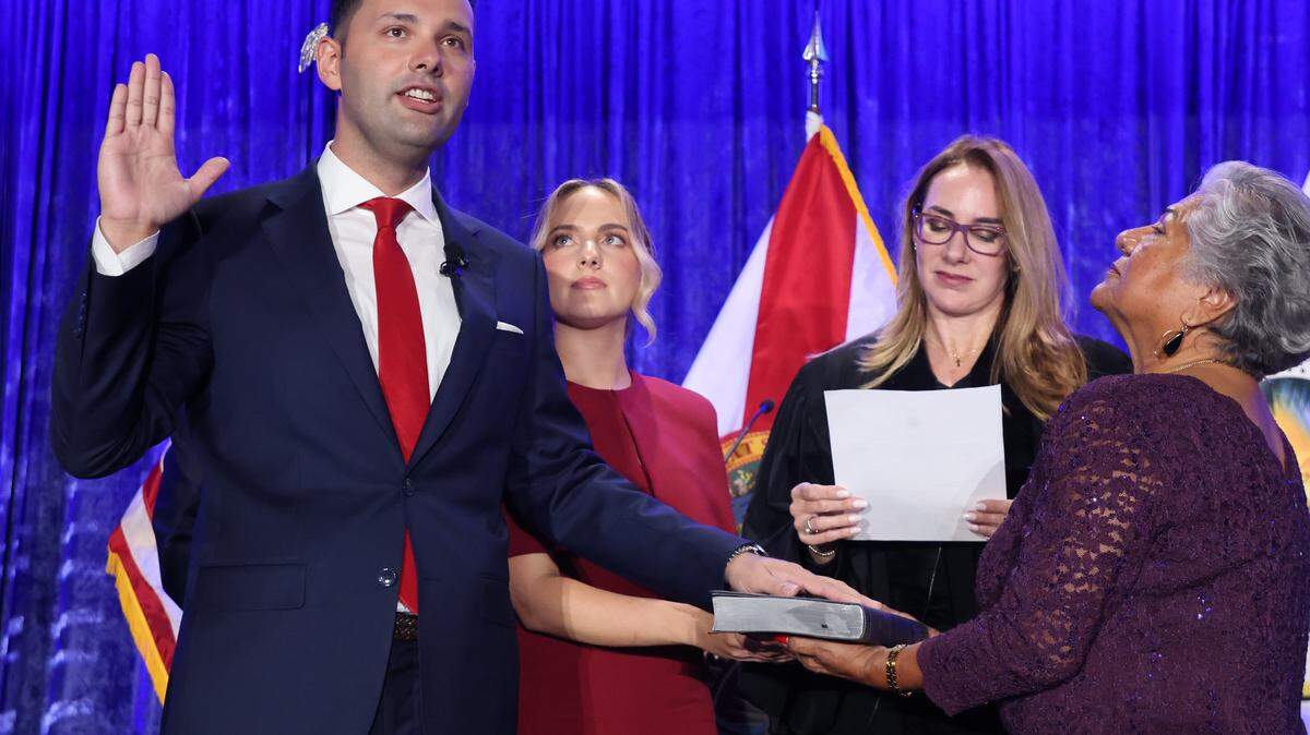 Bryan Calvo, 28, left, is sworn-in by Judge Carmen Cabarga, third from the left, while standing with his girlfriend Melanin Terrero, and his mother Edith Calvo, right, holding the Bible at the Milander Center on Monday, January 12, 2026, in Hialeah, Florida. 


