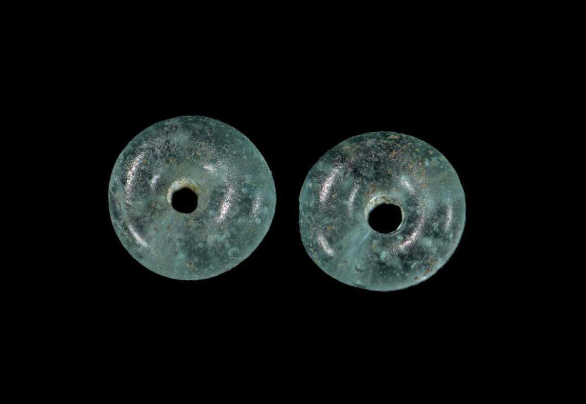 Two blue beads that were excavated from the teenager and child’s burial.