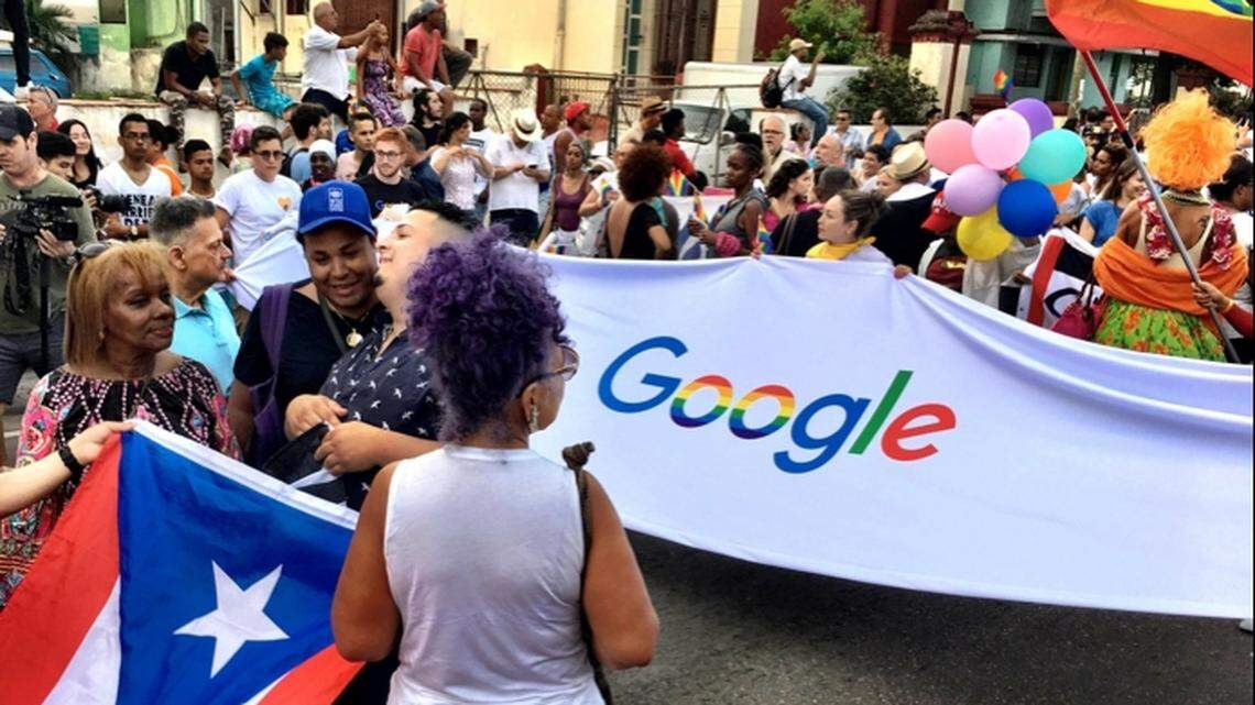 LGBTQ activists attend a pride event in Havana on May 12, 2018, holding a Google banner.