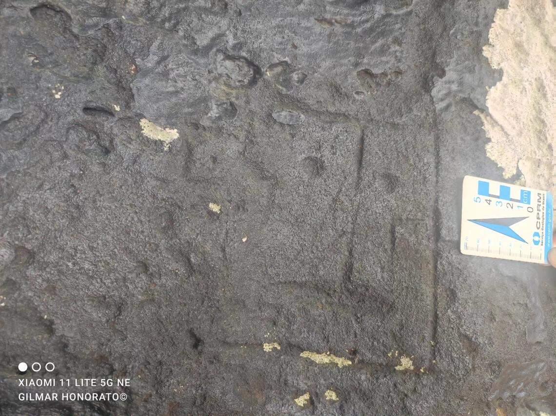 A slightly worn rectangular face carving.