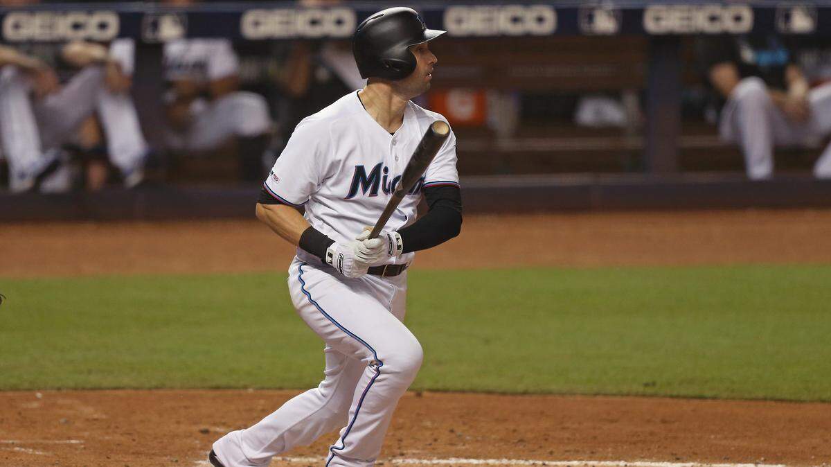 Miami Marlins first baseman Neil Walker (18) hits a single during the fourth inning of a Major League Baseball game against the Cincinnati Reds at Marlins Park in Miami on Wednesday, August 28, 2019.