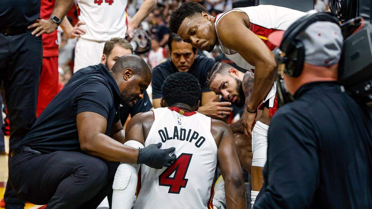 Teammates and staff attend to Miami Heat guard Victor Oladipo (4) after getting injured in the fourth quarter during the game against the Milwaukee Bucks in game 3 of the first-round playoff series at the Kaseya Center in Miami on Saturday, April 22, 2023.