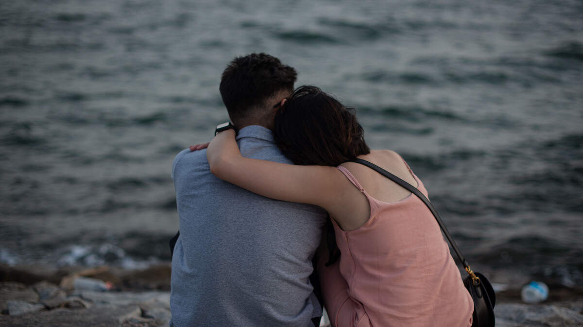 A couple embraces on a breakwater at the Marina East Park on June 06, 2021 in Singapore.