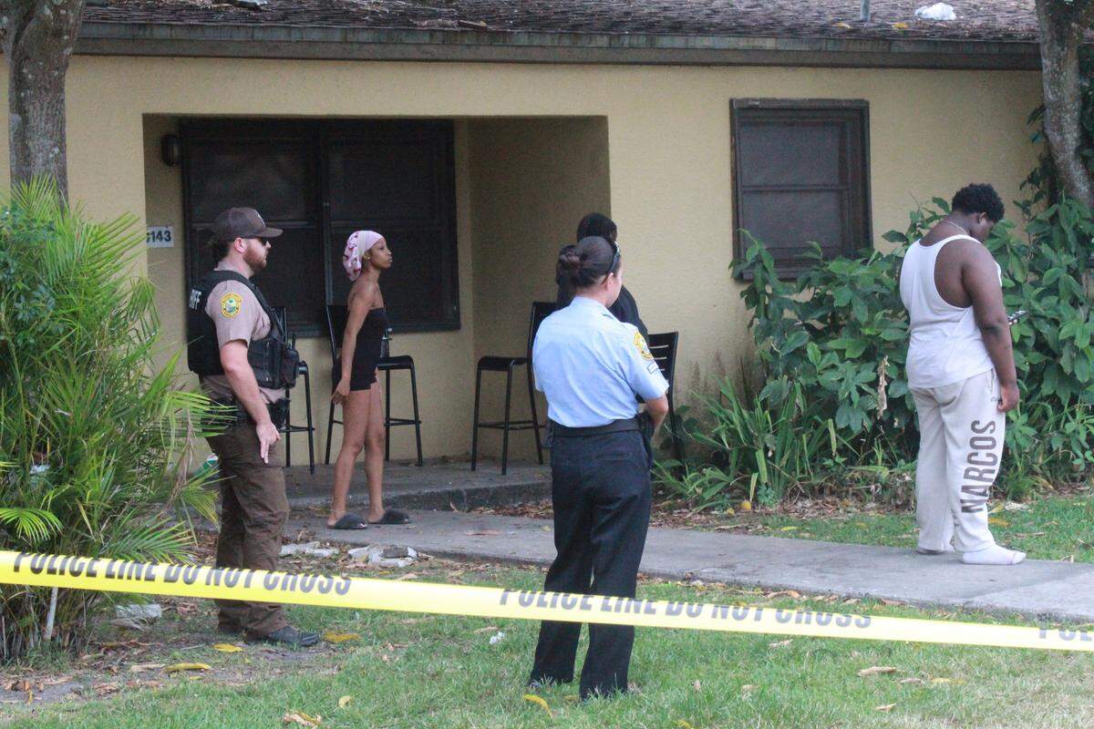 Residents of a southwest Miami-Dade neighborhood stand with sheriff’s office deputies on Tuesday, May 12, 2026, after a 6-year-old boy accidentally shot himself.