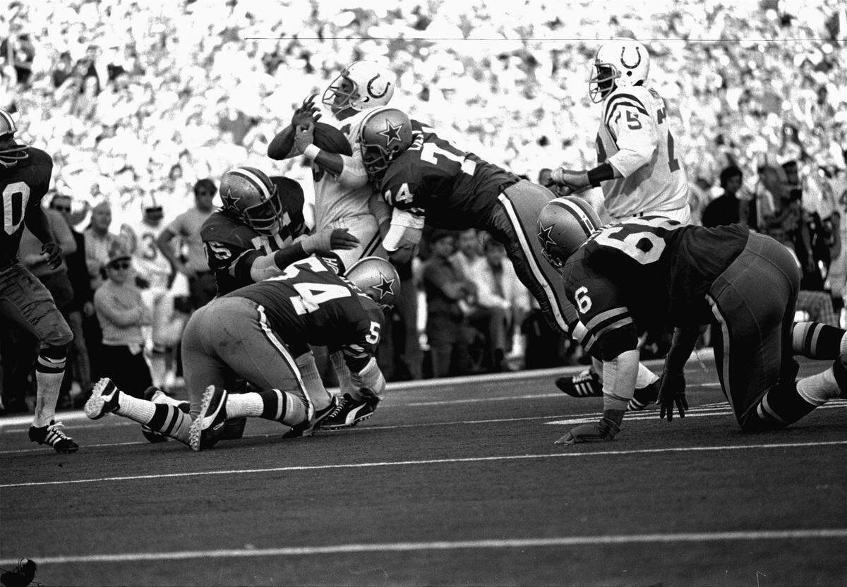 A trio of Dallas Cowboys gang tackle Baltimore Colts linebacker Mike Curtis following his interception late in the fourth quarter of Sunday’s Super Bowl V, January 18, 1971. The interception set up a winning field goal in the final seconds of the NFL championship game, 16-13. Tackling the Colts’ Curtis are Jethro Pugh (75), Bob Lilly (74), and Chuck Howley (54).