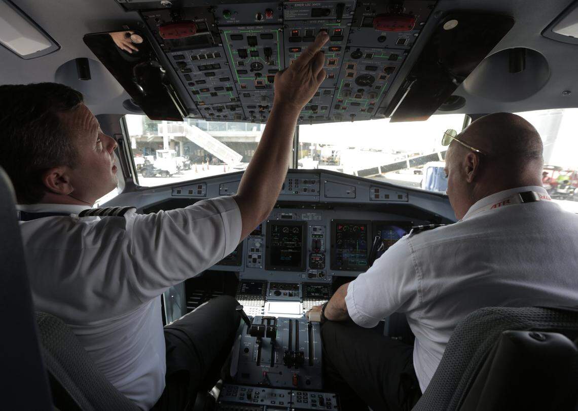 The flight crew goes through their pre-flight check on board a Silver Airways plane on the tarmac at Fort Lauderdale-Hollywood International Airport.