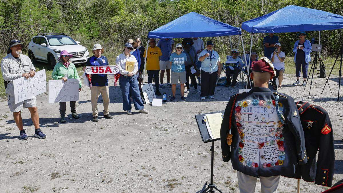 Javier Del Rio, who served in the US Army and Marines, speaks during a May Day Rally outside of Alligator Alcatraz located at the Dade-Collier Training and Transition Airport in the Florida Everglades, Ochopee, Florida, on Friday, May 1, 2026.