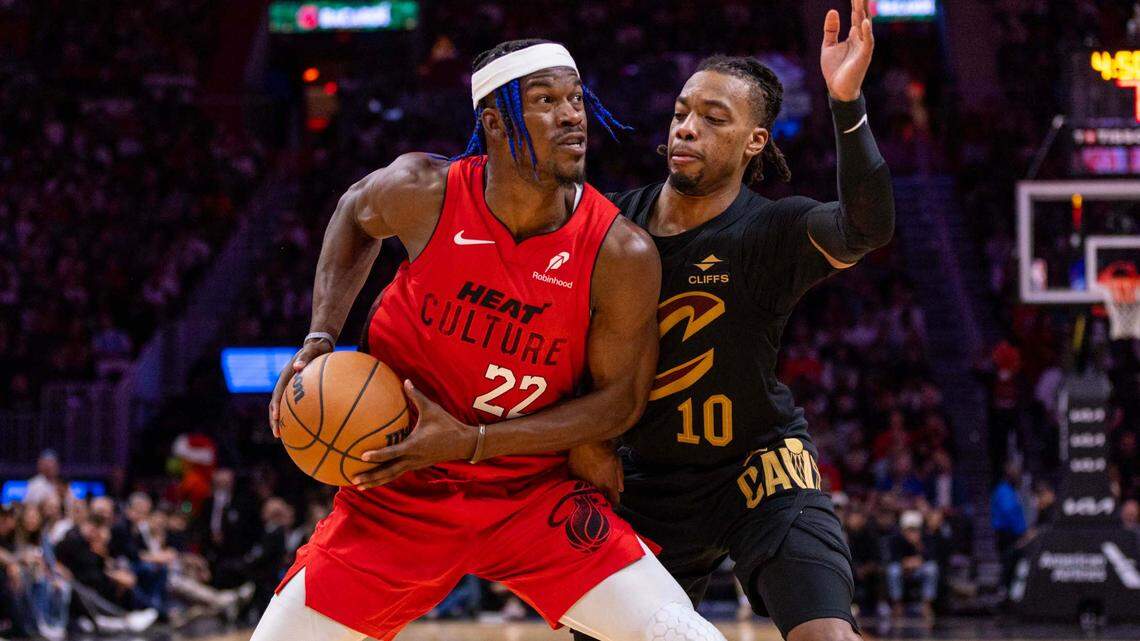 Miami Heat forward Jimmy Butler (22) posts up on Cleveland Cavaliers guard Darius Garland (10) during the second half of an NBA game at Kaseya Center on Sunday, Dec. 8, 2024, in Miami.