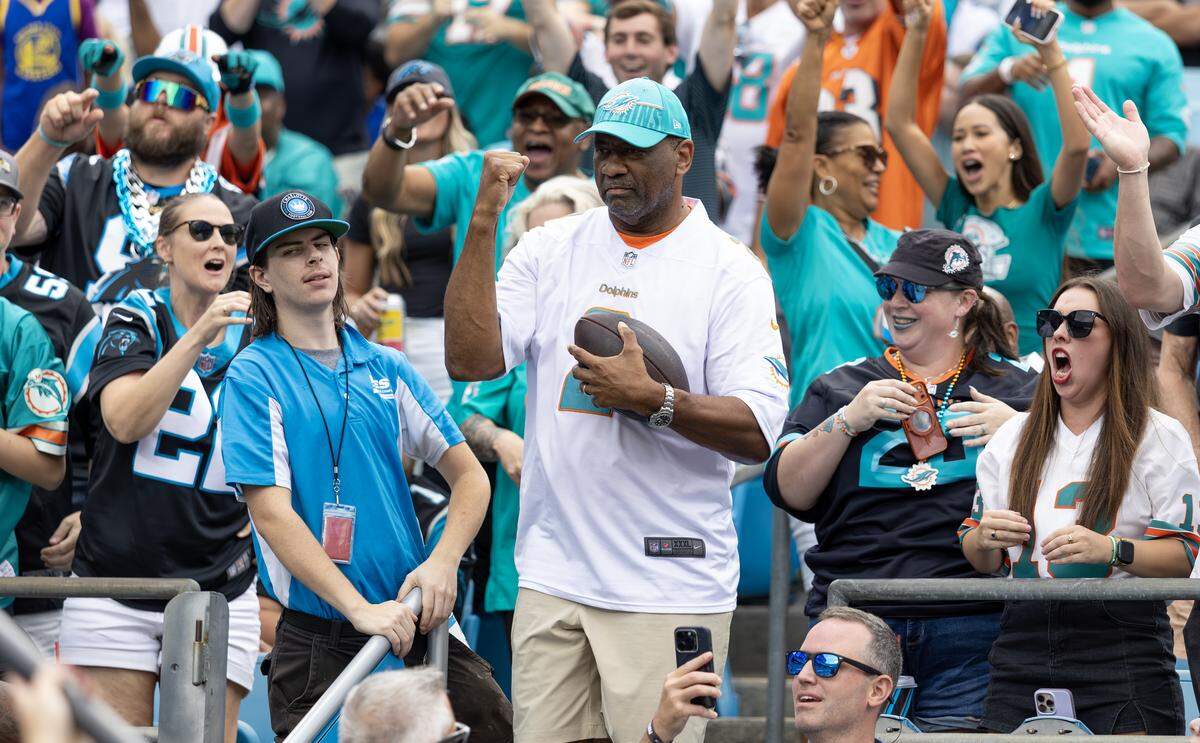 Miami Dolphins fans show their support during the first half of an NFL football game against the Carolina Panthers at Bank of America Stadium on Sunday, Oct. 5, 2025, in Charlotte, N.C.