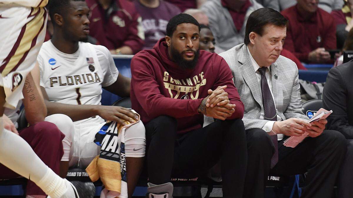 Florida State’s Phil Cofer (0) sits on the bench with a boot on his right foot during the second half of a first round men’s college basketball game against Vermont in the NCAA tournament, Thursday, March 21, 2019, in Hartford, Conn.