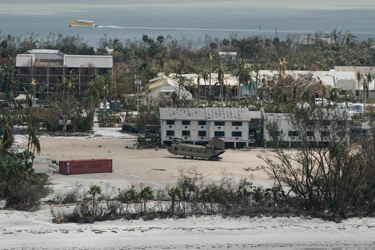 A military helicopter sits down on Sanibel Island in the wake of Hurricane Ian, Thursday, Sept. 29, 2022, in Fla. (AP Photo/Wilfredo Lee)