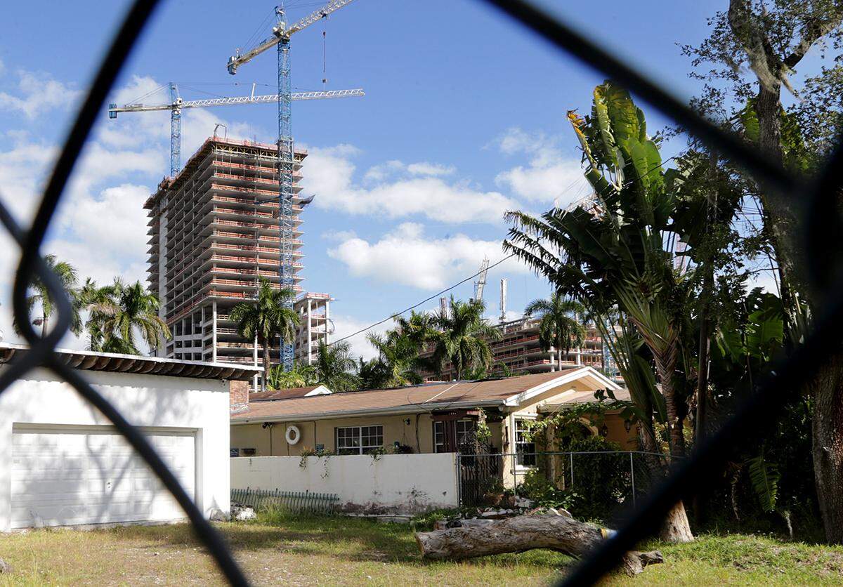 View of typical houses on the south side of the Miami River across the River Landing Shops and Residences construction site.