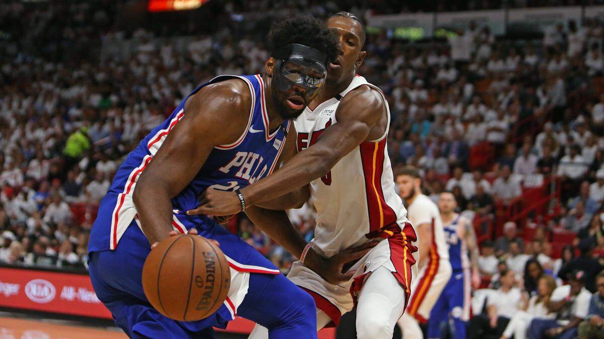 Philadelphia 76ers center Joel Embiid battle for a lose ball against Miami Heat guard Josh Richardson during the third quarter of in Game 3 of a first-round NBA basketball playoff series at AmericanAirlines Arena on April 19.