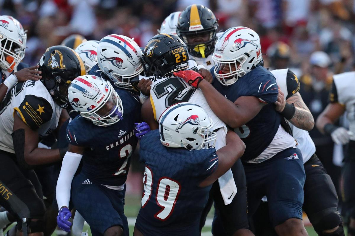 American Heritage running back Byron Louis is swarmed by Chaminade-Madonna defenders during the first half on Friday, Sept. 16, 2022 in Hollywood.