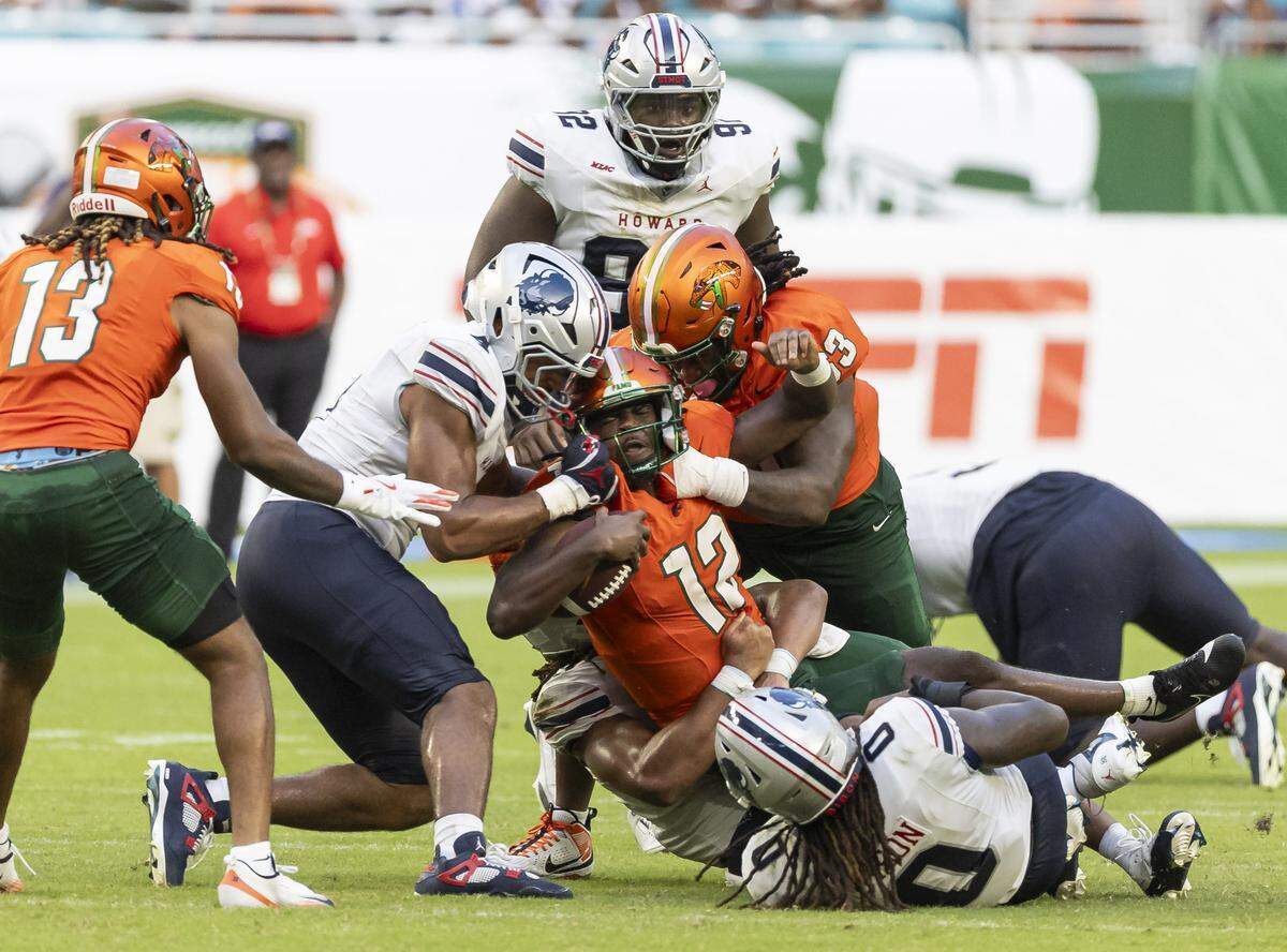Howard Bison linebacker Judah McJimpsey (3) tackles Florida A&M Rattlers quarterback RJ Johnson (12) in the second half of their Orange Blossom Classic football game at Hard Rock Stadium on Saturday, Aug. 30, 2025, in Miami Gardens, Fla.