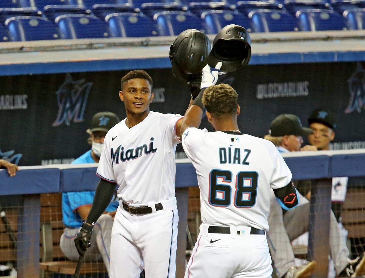Miami Marlins Magneuris Sierra (34) hits helmets with Lewin Diaz (68) after Diaz hit a home run during a simulated game at Marlins Park, Miami, Florida, July 9, 2020.