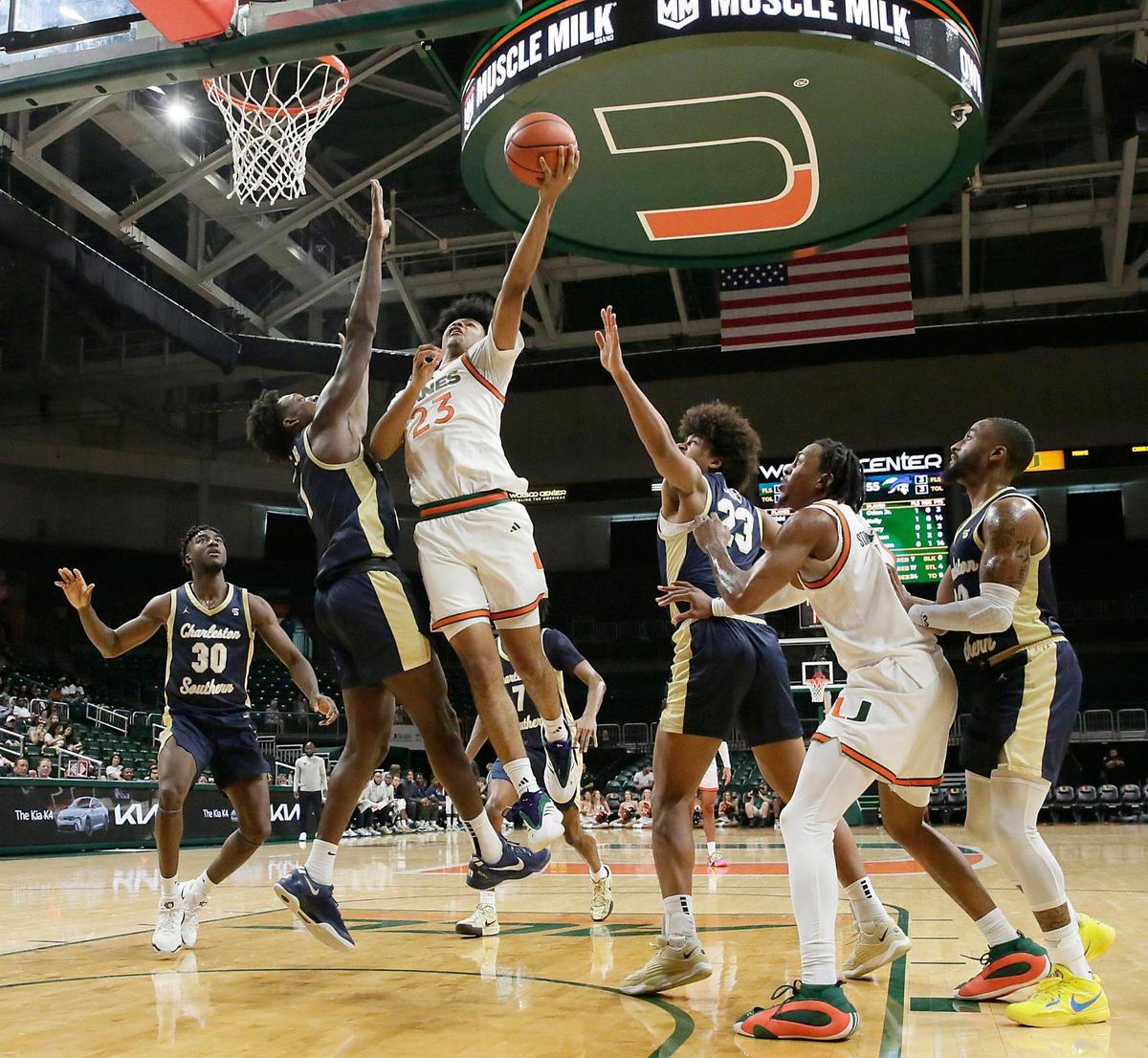 UM Hurricanes Austin Swartz (23) shoots over Charleston Southern University Buccaneers Lamar Oden Jr. during the basketball game on Saturday, November 30, 2024 at Watsco Center in Coral Gables. Andrew Uloza / for Miami Herald