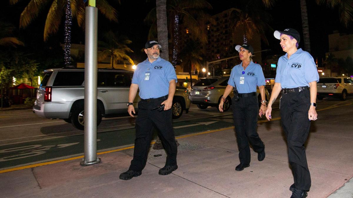 Civilian Volunteer Patrol members walk along Washington Avenue after a press conference introducing the new initiative outside Miami Beach Police Department headquarters in Miami Beach, Florida, on Monday, Dec. 13, 2021. The CVP utilizes trained volunteers to deter crime and report quality of life issues.