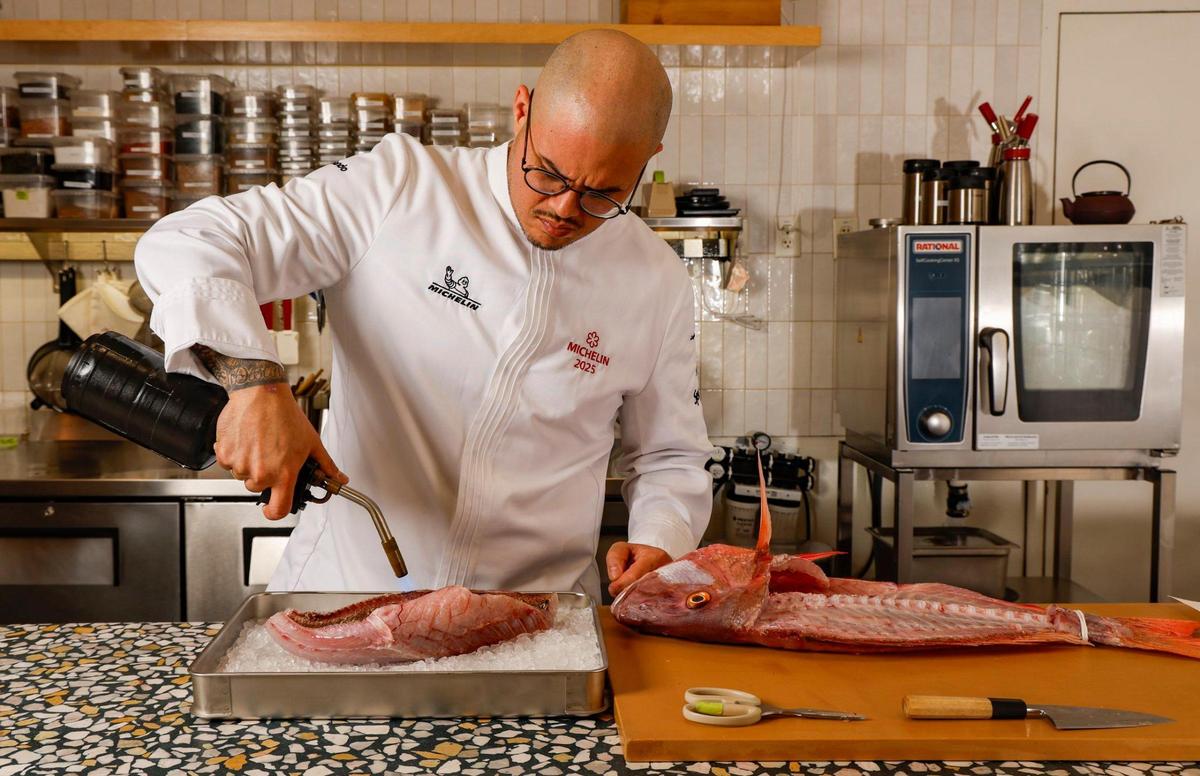 Chef Nando Chang prepares snapper at Itamae Ao in Miami’s Design District.