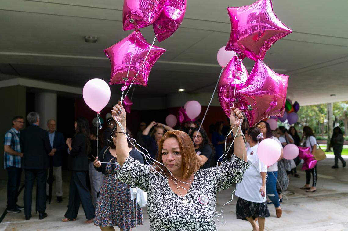 Gina Duran, the mother of Alexa Duran, holds balloons before the unveiling of a memorial at Florida International University in Miami, Florida on the fourth anniversary of the FIU bridge collapse on Tuesday, March 15, 2022. The bronze statue, which was made by Brian Hanlon, aims to honor the memory of FIU student Alexa Duran and the other five victims who were killed when a pedestrian bridge, still underway, collapsed on March 15, 2018.
