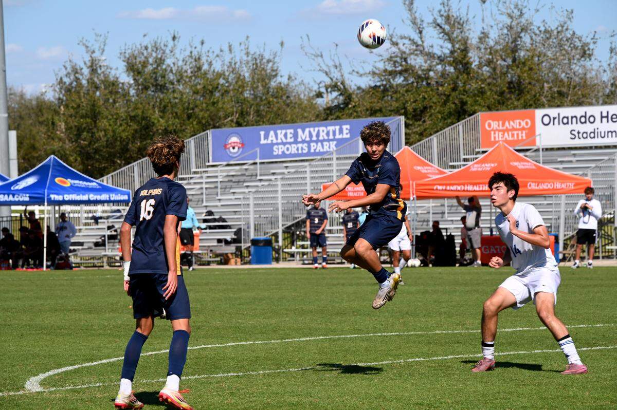 Downtown Doral senior Heber Morales (middle) heads the ball toward Somerset Canyons’ goal during Saturday’s Class 3A state boys’ soccer championship at the Lake Myrtle Sports Complex in Auburndale, Fla.