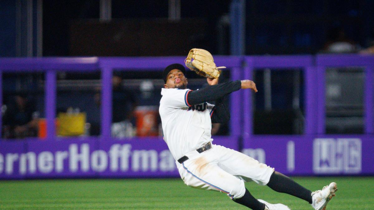 Miami Marlins shortstop Xavier Edwards (63) throws the ball the first base while diving during the fourth inning of a baseball game on Monday, Aug. 5, 2024, at loanDepot Park in Miami.