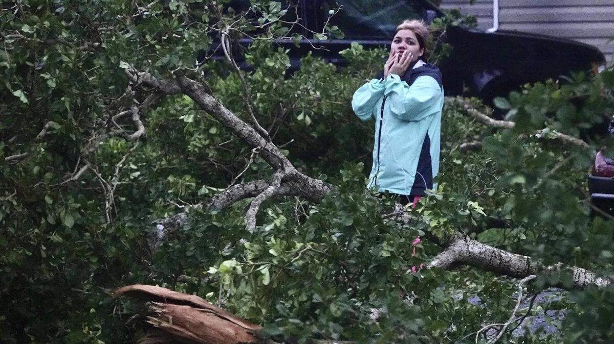 Broward County resident Zuram Rodriguez surveys the damage around her mobile home in Davie early Wednesday.