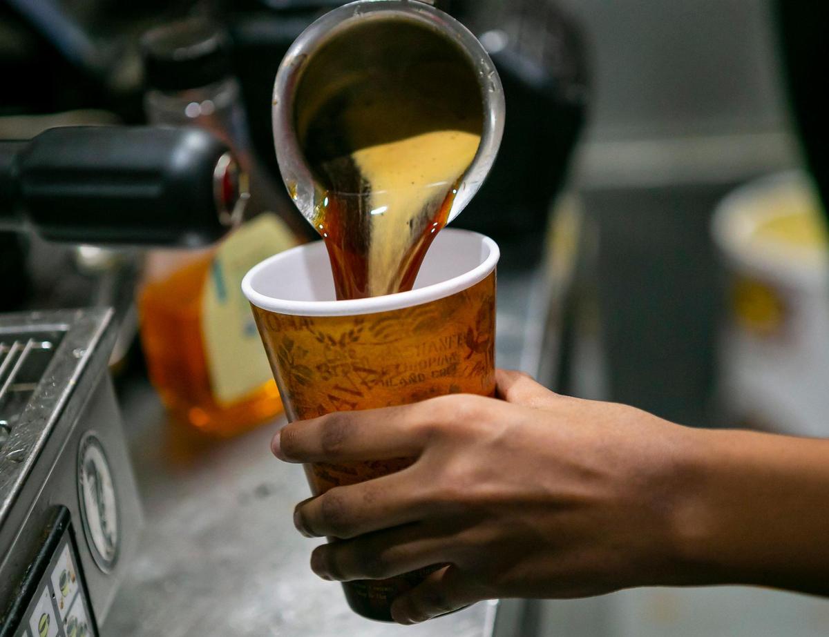 Preparing an Americano at Groovin’ Bean Coffee Bar & Lounge in Overtown.