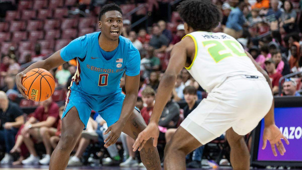 Florida State Seminoles guard Chandler Jackson (0) reacts as South Florida Bulls forward Sam Hines Jr. (20) defends in the first half of their Orange Bowl Basketball Classic game at the Amerant Bank Arena on Saturday, Dec. 9, 2023, in Sunrise, Fla.