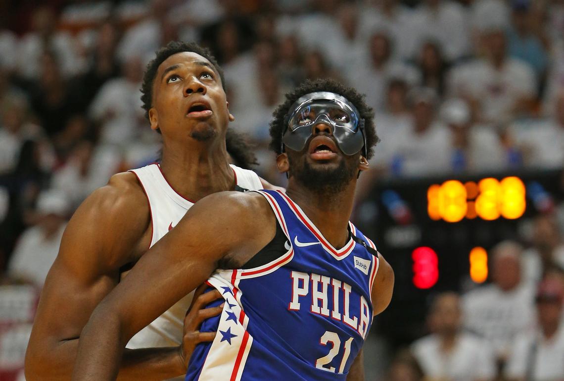 Miami Heat center Hassan Whiteside fights for position under the basket against Philadelphia 76ers center Joel Embiid during the first quarter of Game 3 of the first-round NBA basketball playoff series at AmericanAirlines Arena in Miami on Thursday, April 19, 2018.
