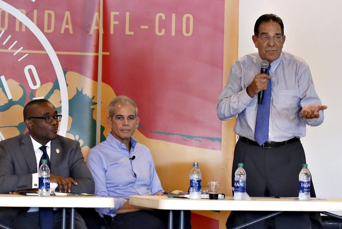 Mayoral candidate Xavier Suarez, right, answers a question as Jean Monestime, left, and Alex Penelas listen during the Miami-Dade County Mayoral Candidate Forum at the Firefighters Memorial Hall in Doral on Monday, October 21, 2019.