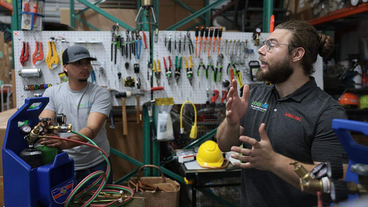 Instructor Bryan Vela (right) teaches Marcos Cofre about brazing heating, ventilation and air conditioning systems at the Level5HVAC construction trade school on May 9, 2026, in Homestead, Florida. Vocational trade schools have seen an uptick in interest as AI threatens the traditional job market.