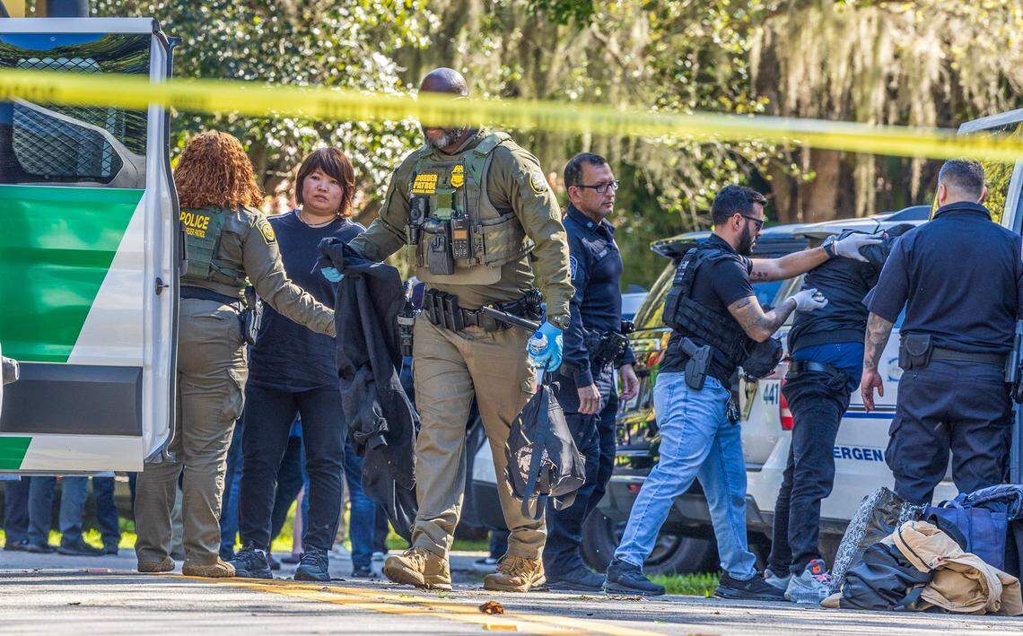 Coral Gables Police, working with federal agents, detain Chinese nationals off Old Cutler Road and Southwest 116th Street in Coral Gables on Jan. 28, 2025. A total of 28 Chinese migrants were picked up, while four men were charged with smuggling, a federal complaint says.