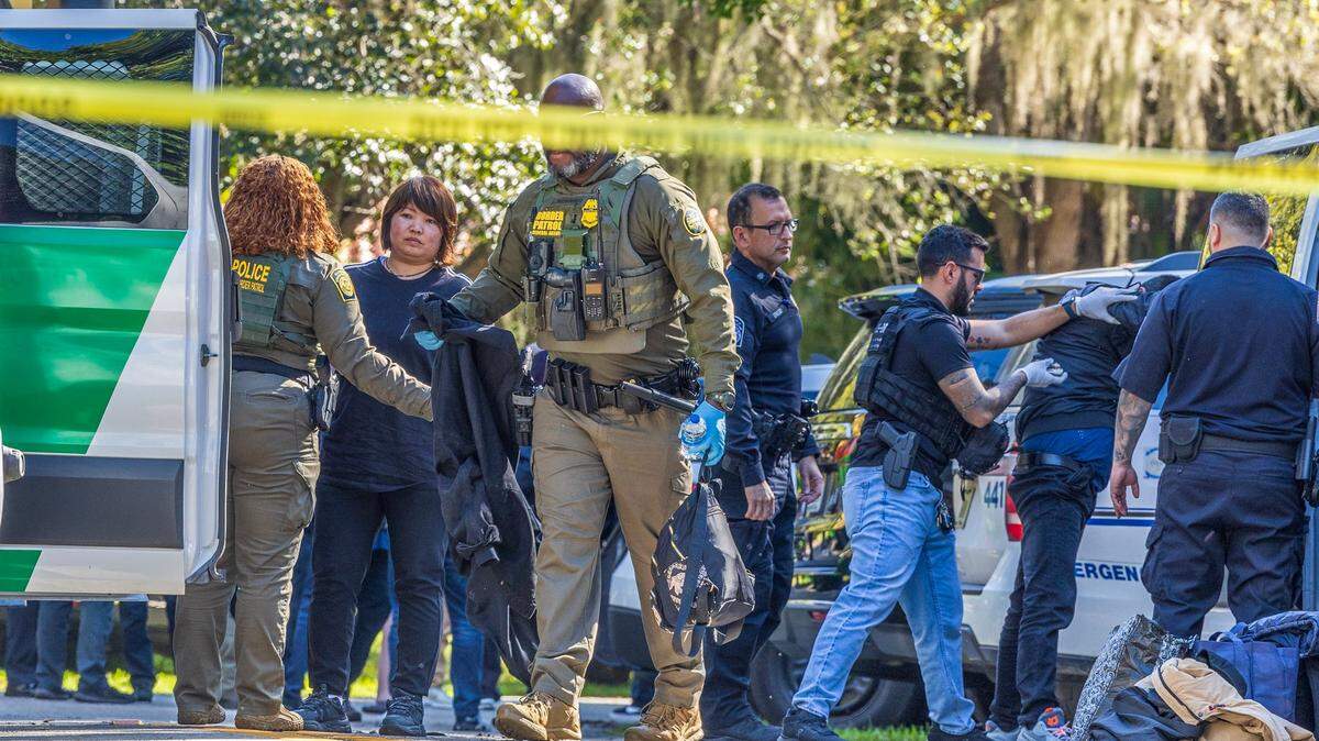 Multiple law enforcement officers are on the scene at Old Cutler Road and Southwest 120th Street in Coral Gables, where Coral Gables police detained Chinese migrants in the area on Tuesday, January 28, 2025.
