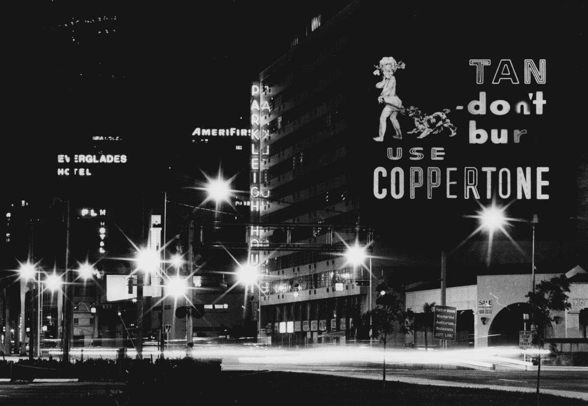 The famous Coppertone sign in Miami lit up at night in 1982.