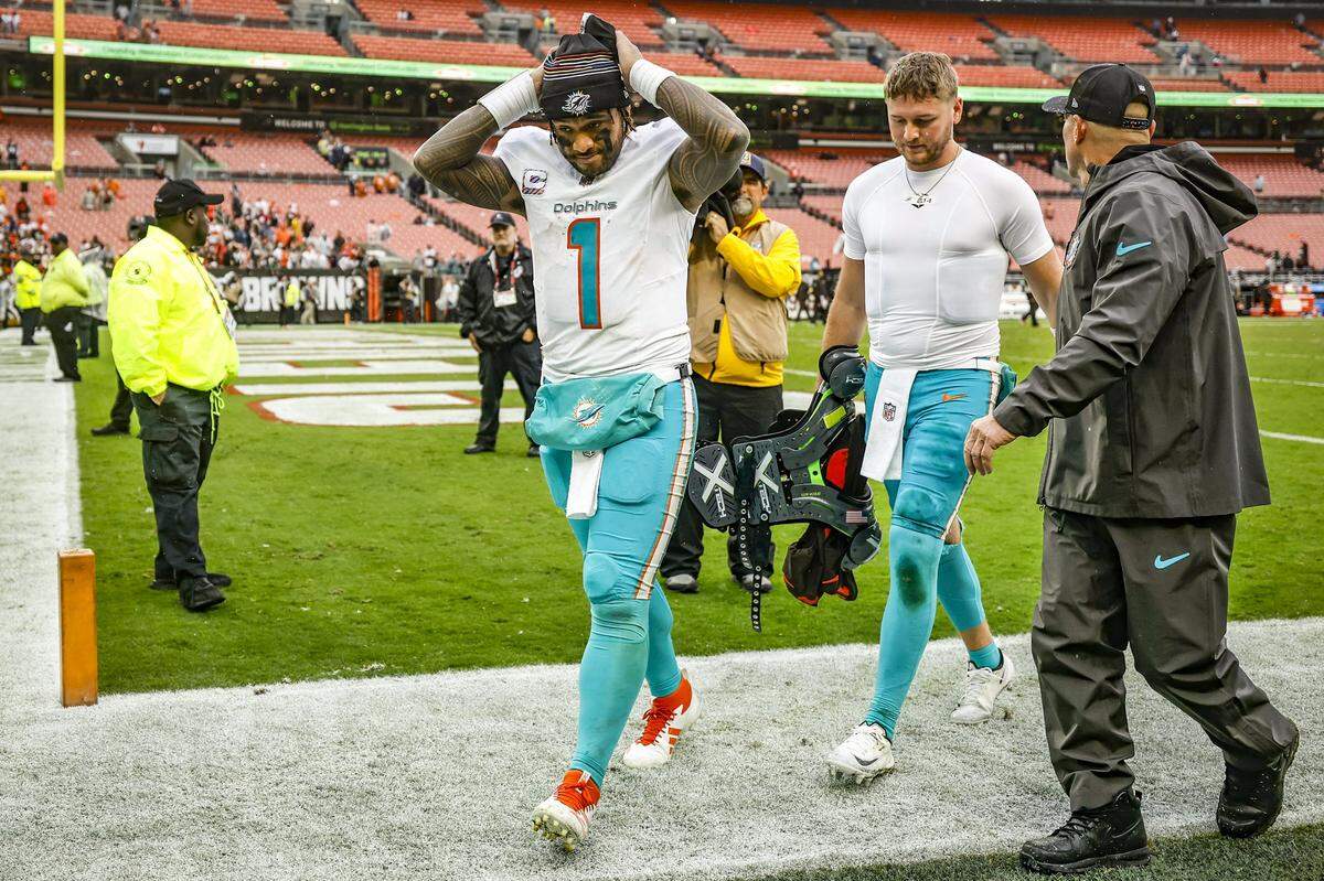 Miami Dolphins quarterbacks Tua Tagovailoa (1) and Quinn Ewers (14) walk off the field after the loss against the Cleveland Browns of their NFL football game at Huntington Bank Field in Cleveland, Ohio, on Sunday, October 19, 2025.