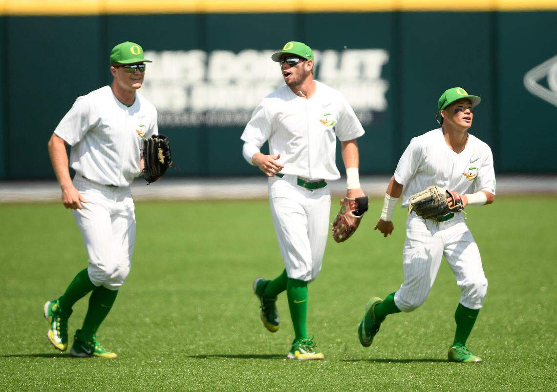 Oregon Ducks outfielder Tanner Smith (31), centerfielder Colby Shade (26), and infielder Rikuu Nishida (56) celebrate the win over Xavier Musketeers during the ninth inning during the Nashville Regional at Hawkins Field.