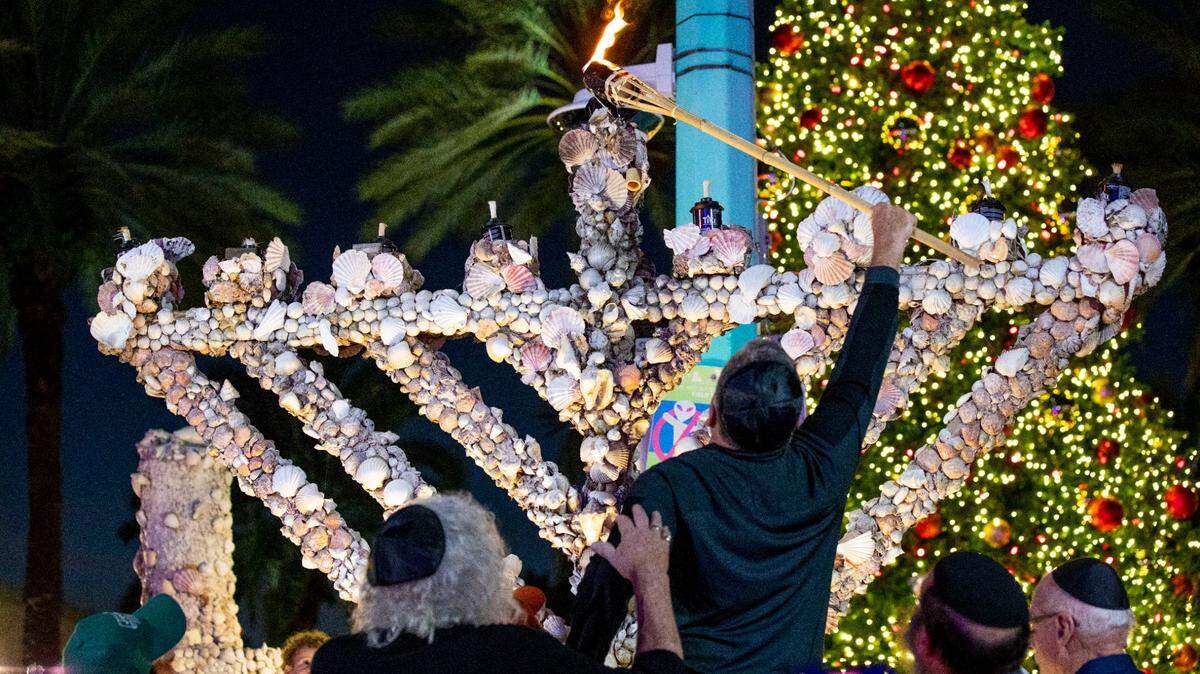 The community gathered to light artist Roger Abramson’s unique seashell-covered menorah and mark the first night of Hanukkah on Lincoln Road in Miami Beach on Nov. 28, 2021.
