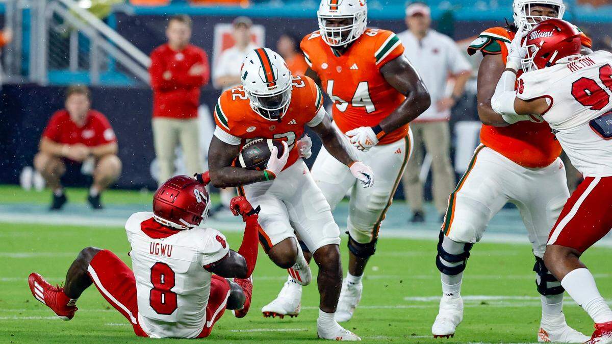 Miami Hurricanes running back Mark Fletcher Jr. (22) goes up against Miami of Ohio Redhawks defensive lineman Brian Ugwu (8) in the first half in Miami Gardens, Florida on Friday, September 1, 2023.