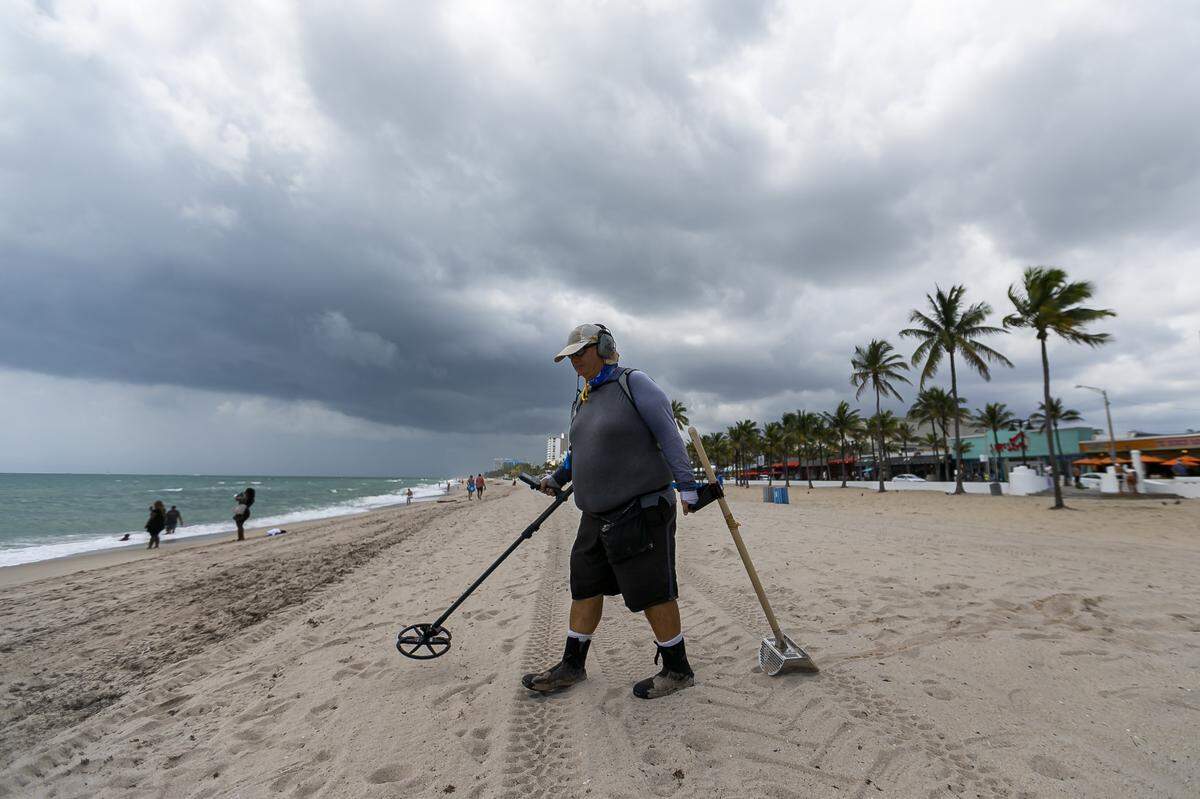 Craig Martin, 60, a Margate resident, walks down Las Olas Beach in Fort Lauderdale with his metal detector on Tuesday.